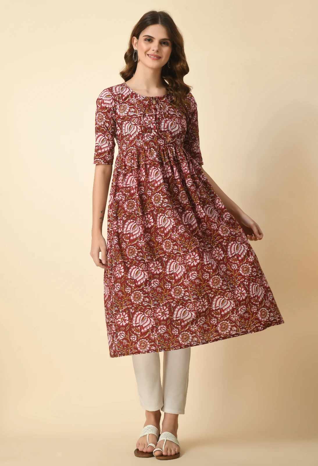 Front view with the hem held out to show the kurta's wide Anarkali drape and midi length