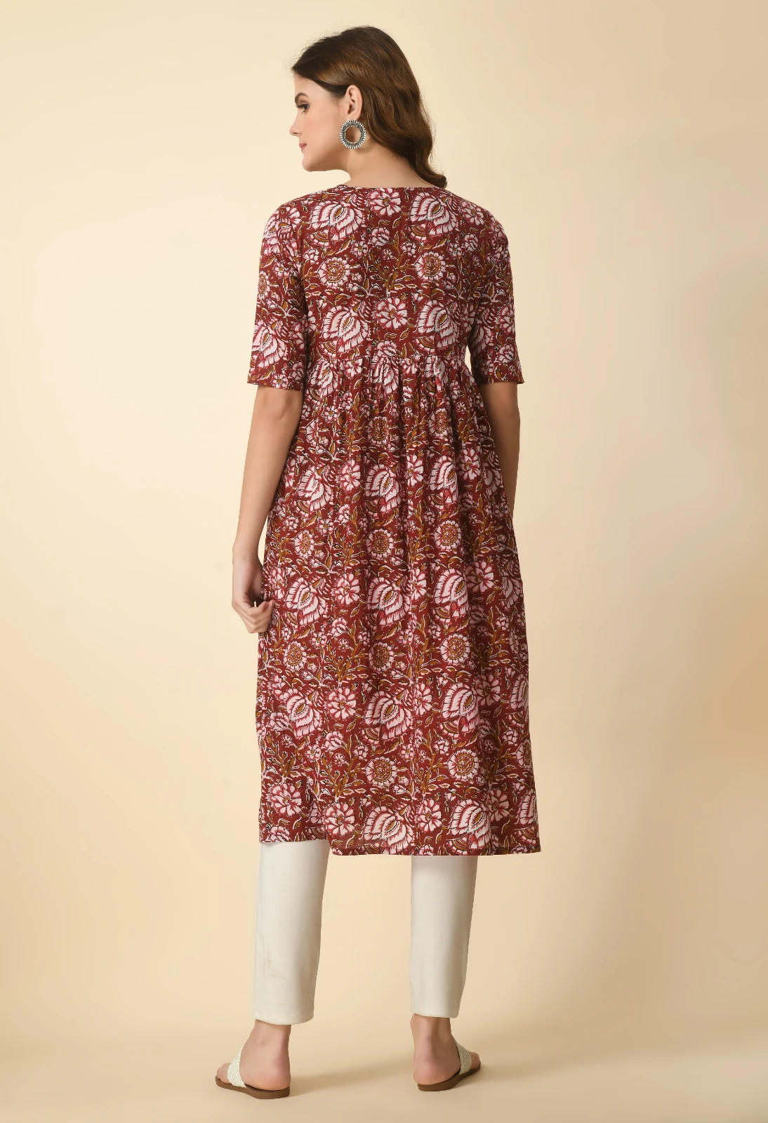 Back view of the rust floral kurta showing the printed rear panel and elbow-length sleeves