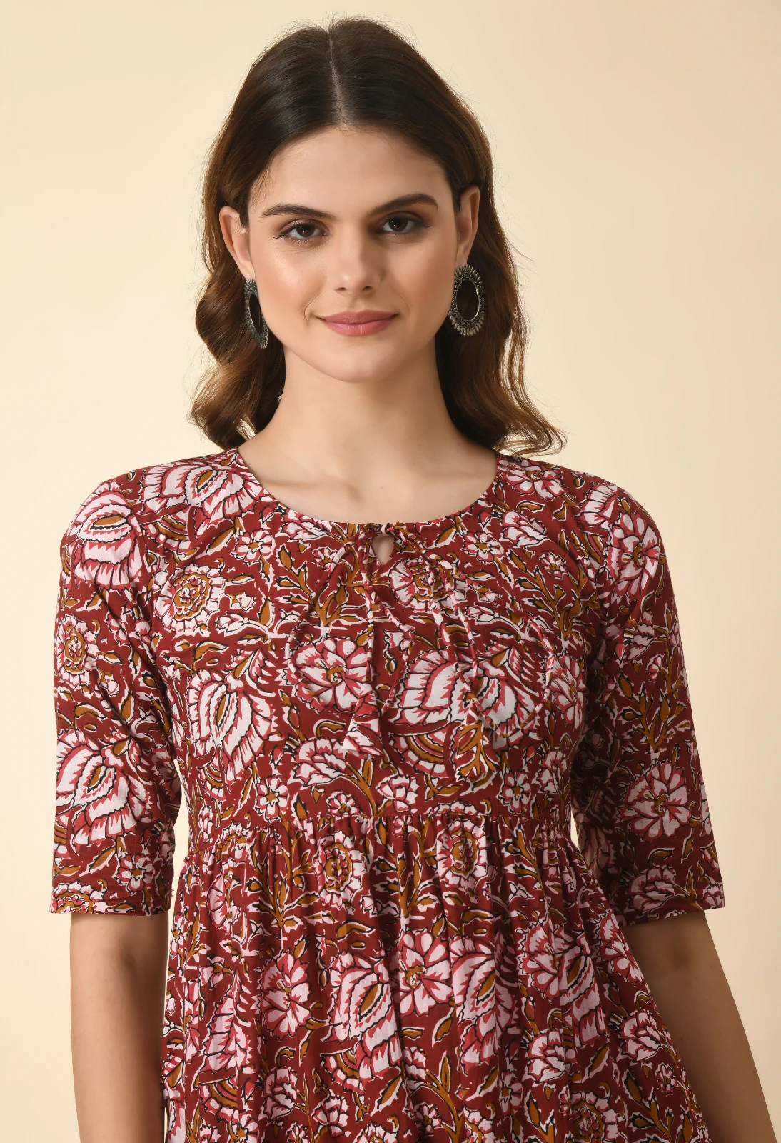 Upper-body view of the rust floral kurta with gathered empire waist and elbow-length sleeves