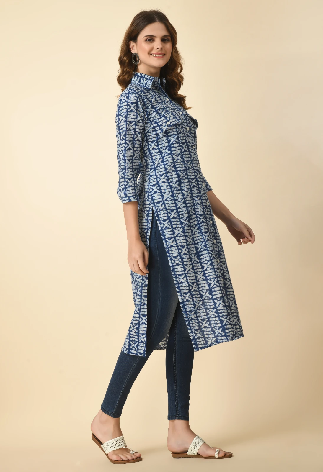 Angled front view showing chest flap pockets, white buttons, and side slit of the blue printed kurta