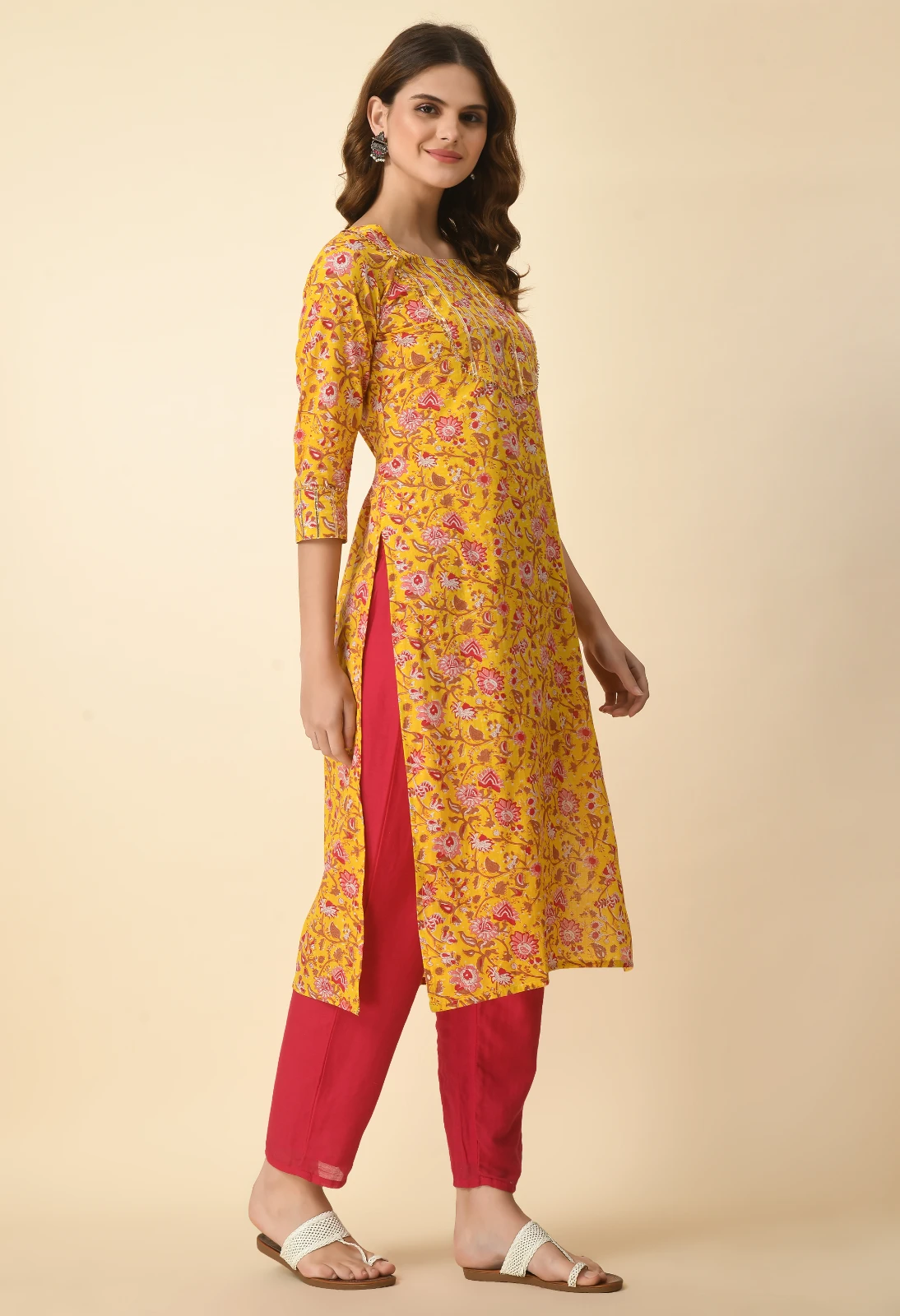 Three-quarter angled view highlighting the kurta's side slit and allover floral print