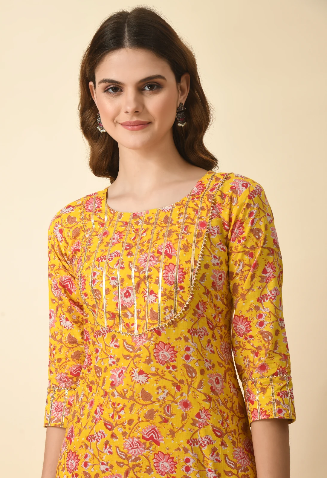 Close front view highlighting the scoop neckline, pintuck yoke and cuffed three-quarter sleeves