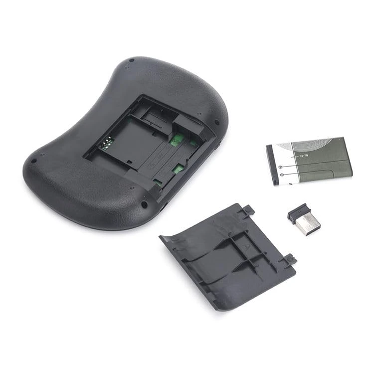 Angled rear layout showing the keyboard body, detached battery cover, USB dongle and slim battery pack