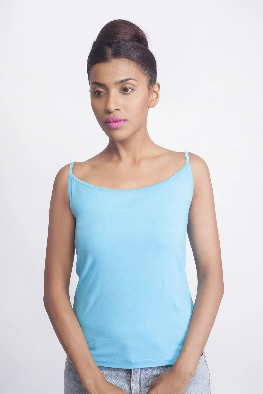 Women's sky blue fitted camisole on a model, front view with thin straps and a wide square neckline