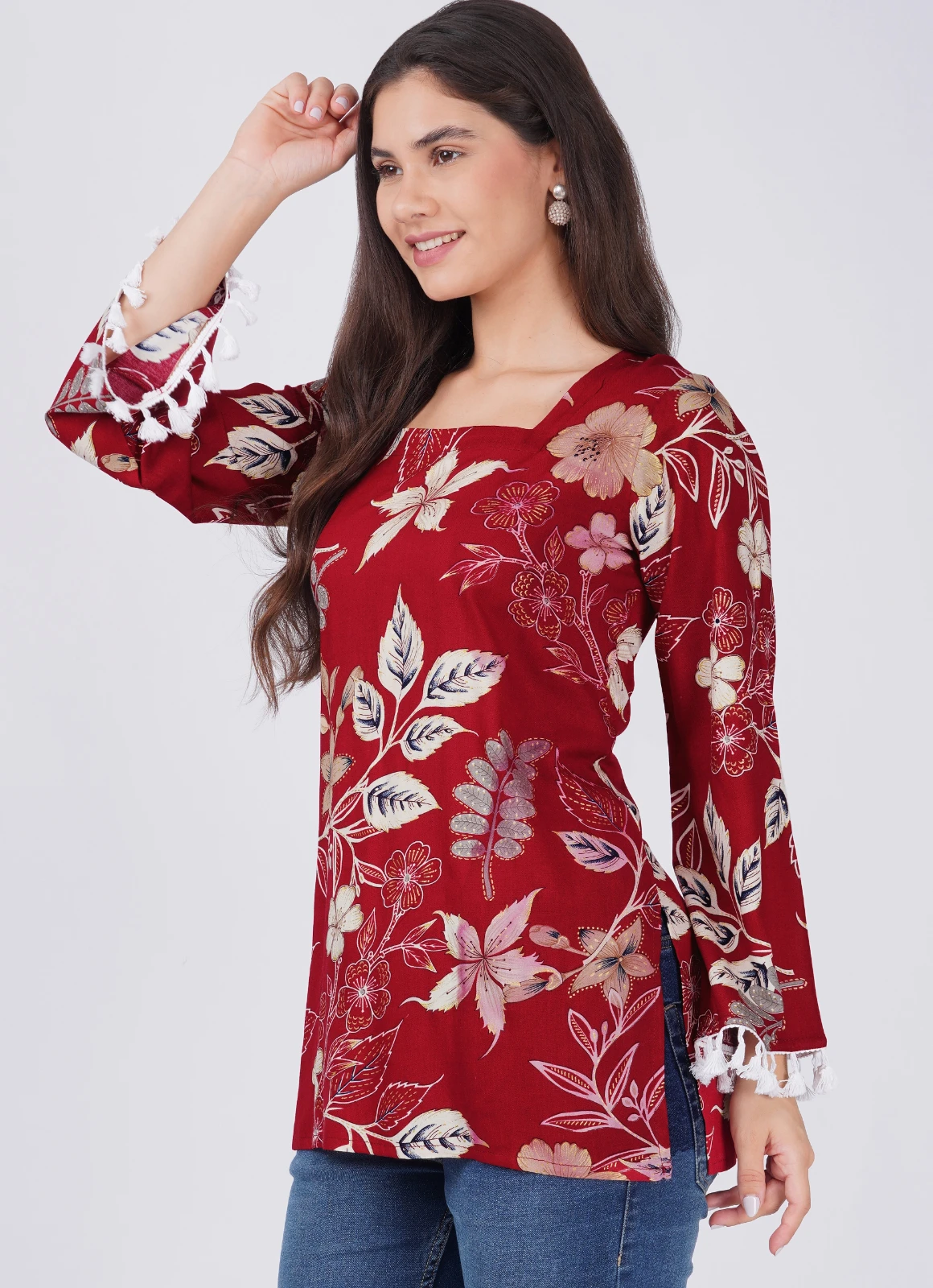 Angled front view highlighting the square neck and white tassel cuffs