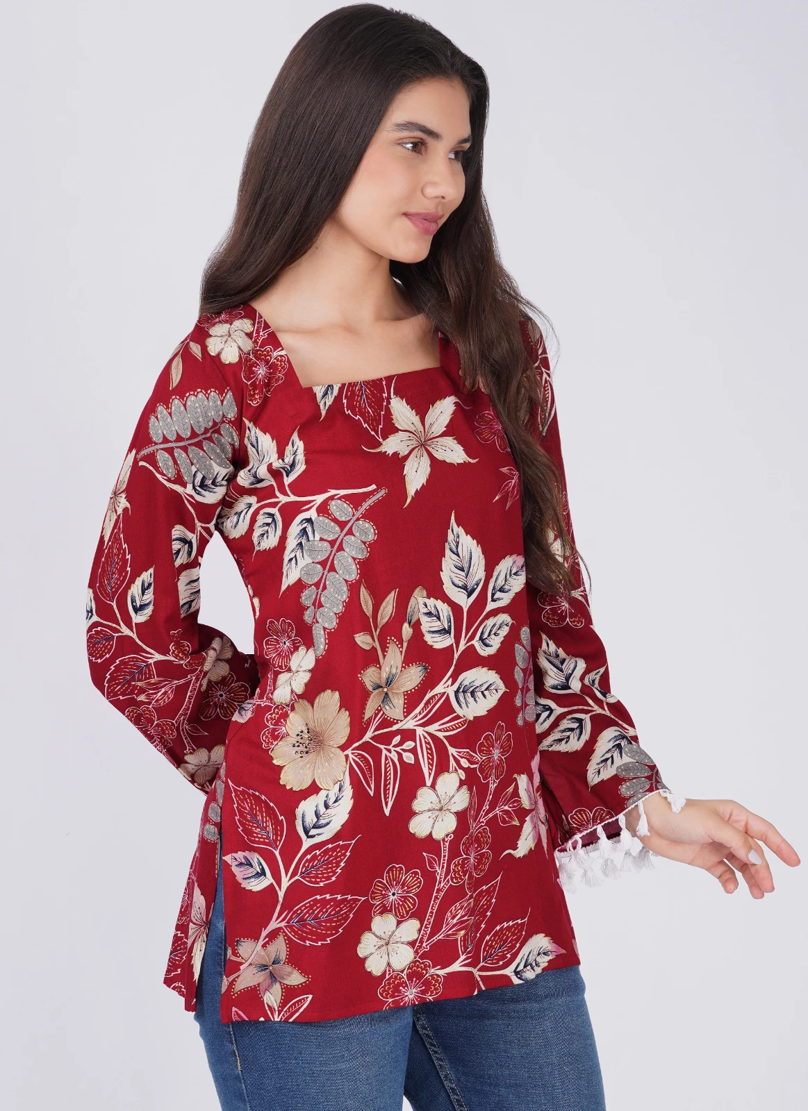 Side-front view of the floral printed top with side slit and flared sleeves