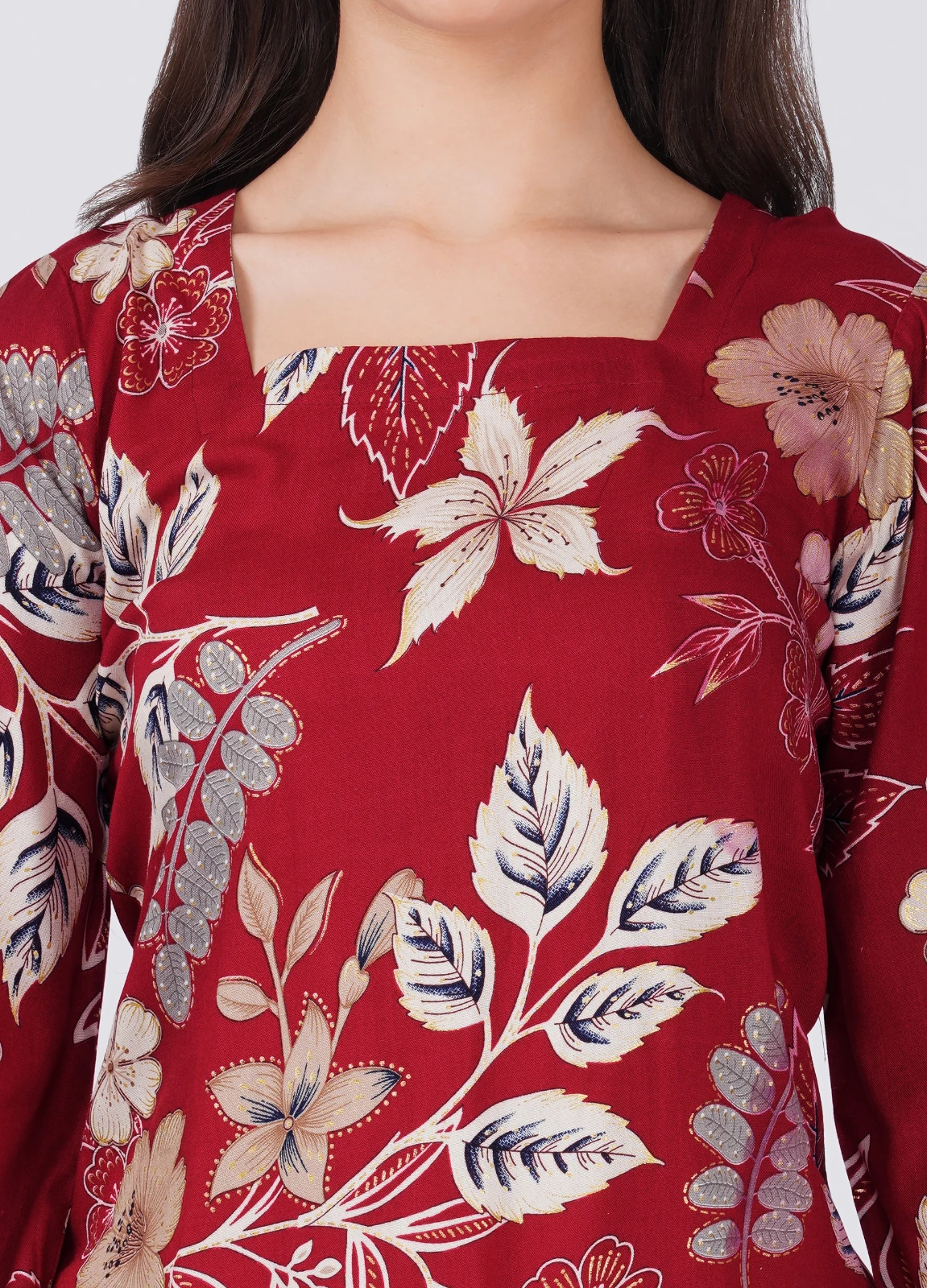 Close-up of the square neckline and floral print on maroon fabric