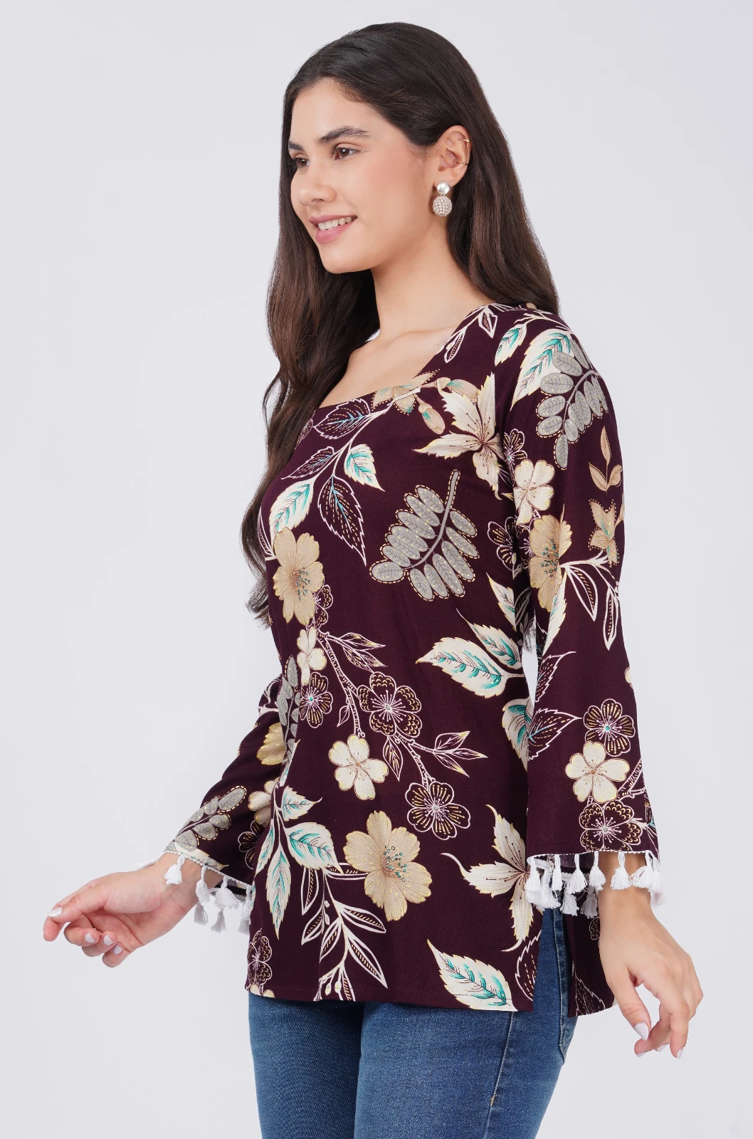 Right side profile highlighting the straight hem, side slit and flared tassel-trim sleeve