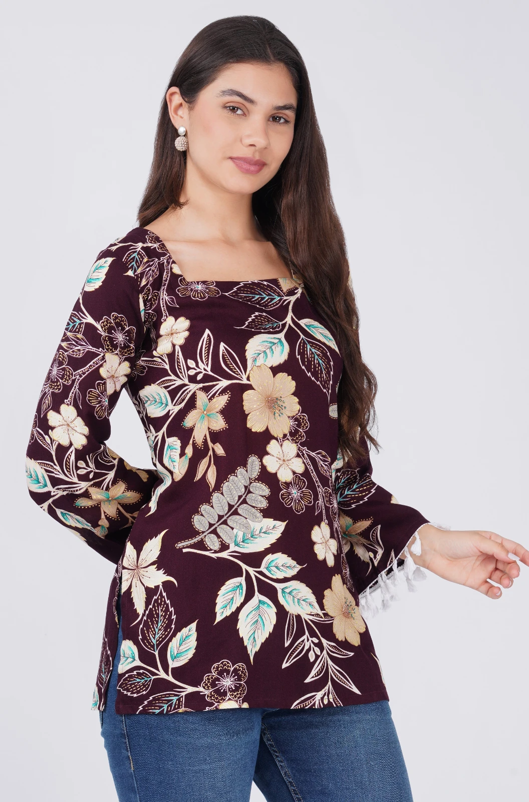 Angled front close view showing fitted waist and large beige floral print on deep burgundy fabric