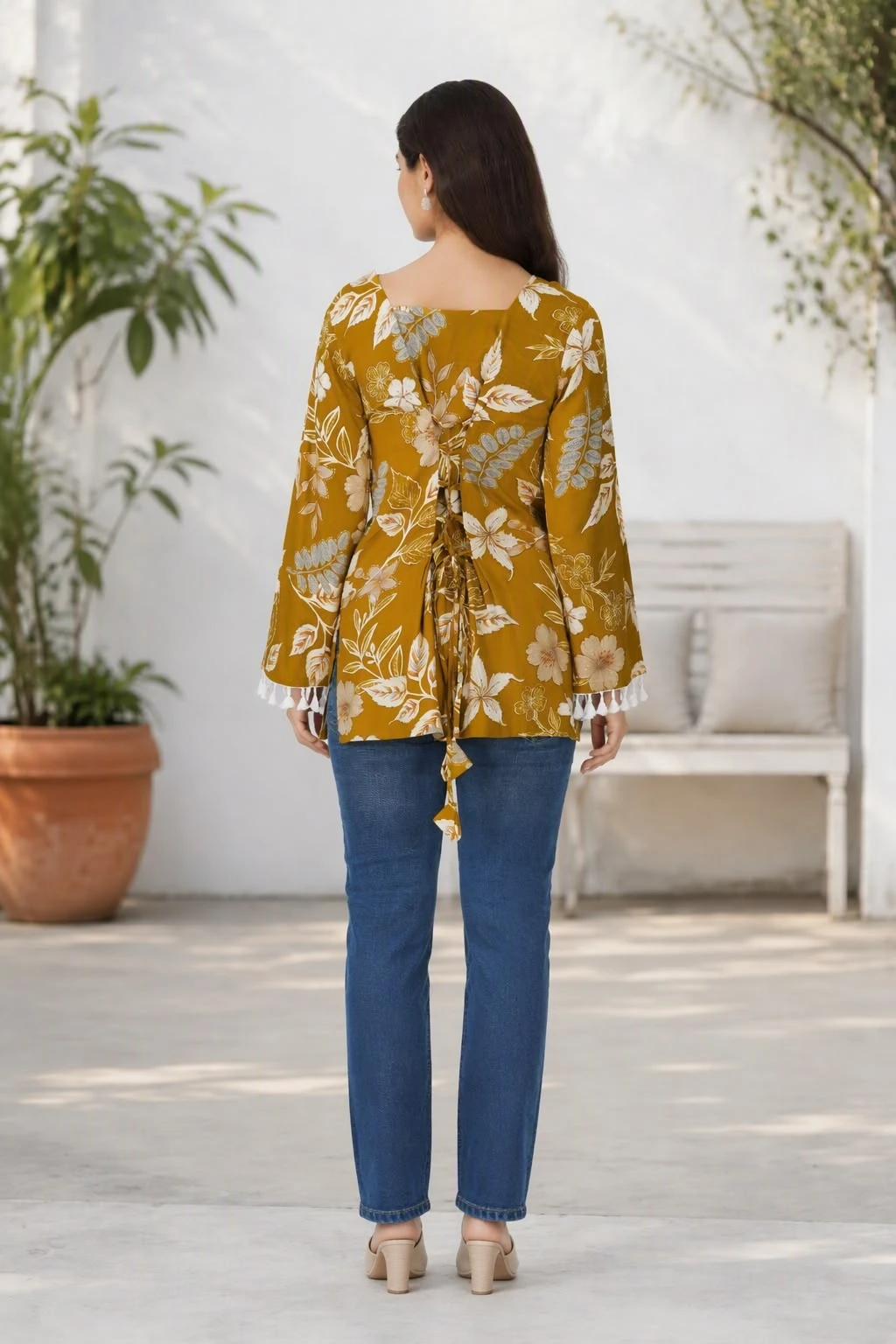 Back view showing the square back neckline and tie detail at the waist