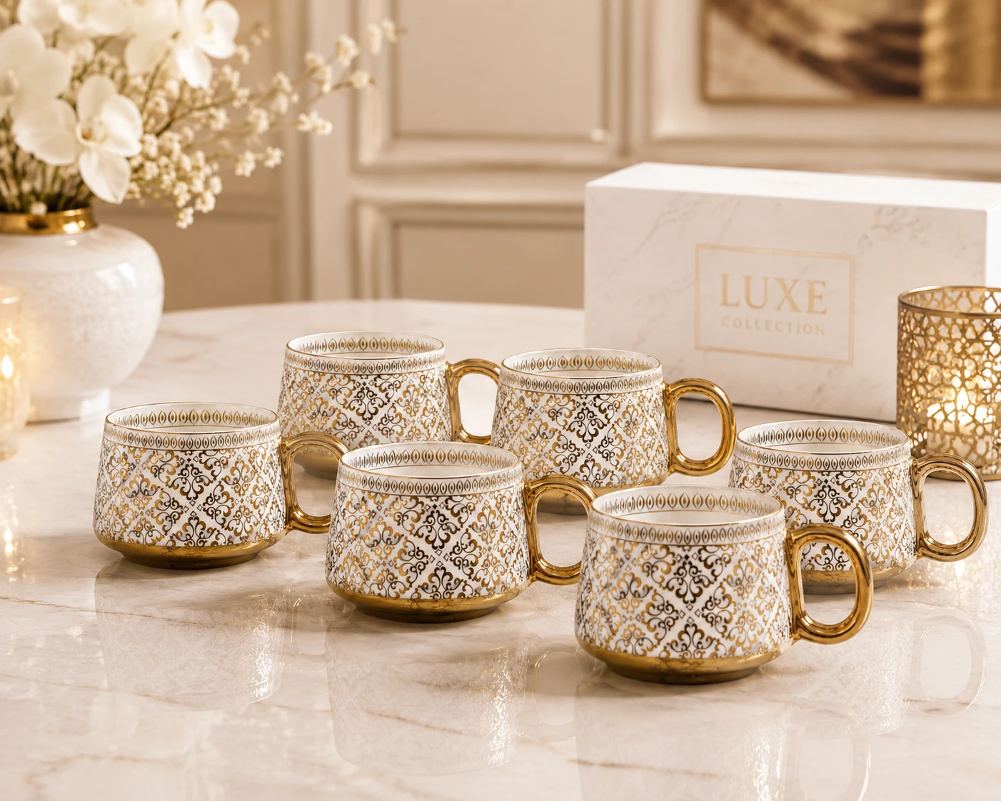Set of six patterned mugs arranged on a marble table with Luxe Collection box and candlelit decor