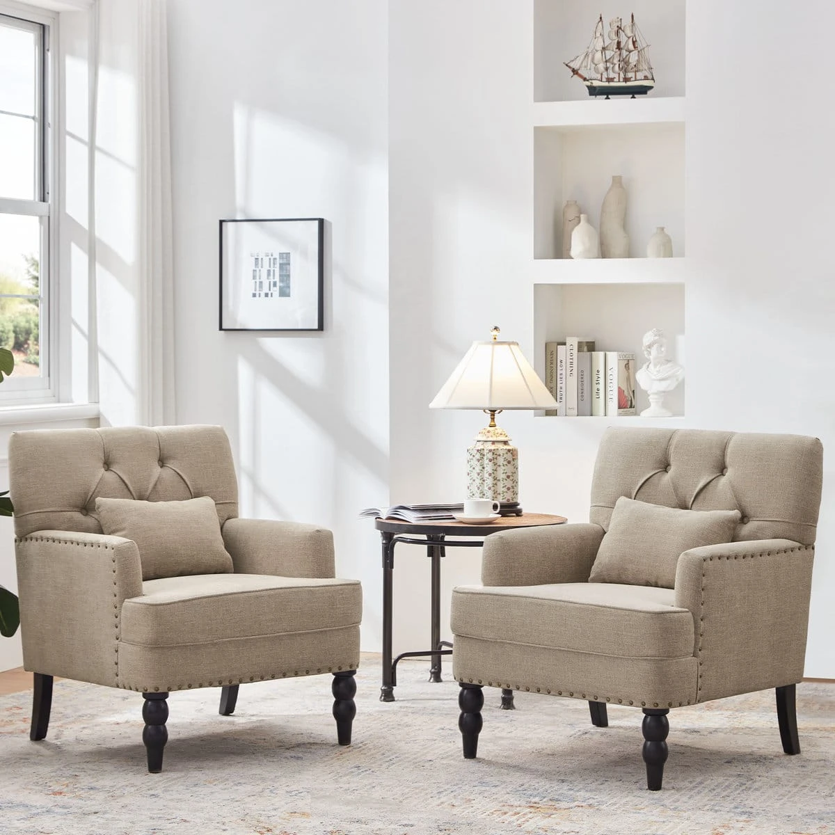 Styled living room scene showing two matching brown tufted armchairs beside a round side table