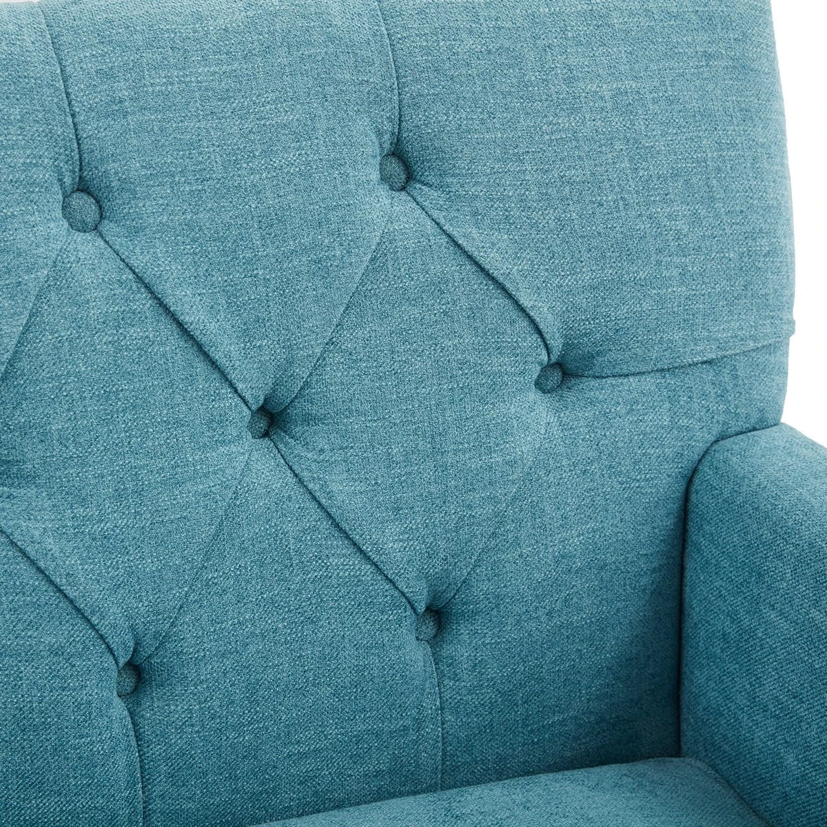 Close-up of the sky blue fabric backrest with diamond button tufting beside the padded arm