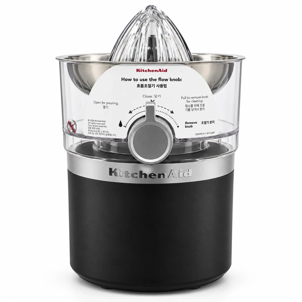 Front view of black KitchenAid citrus juicer with clear reamer and instruction label over the flow knob