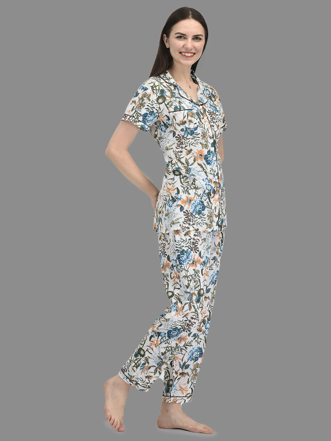 Angled side view highlighting the button-front shirt, chest pocket and ankle-length printed pyjama pants