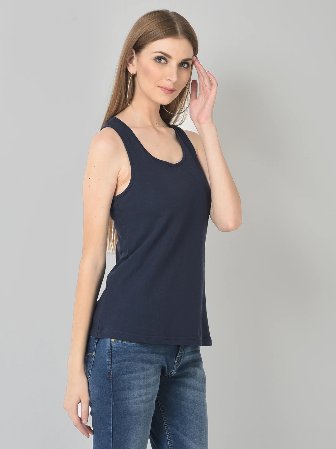 Three-quarter front pose showing armhole cut and straight hemline