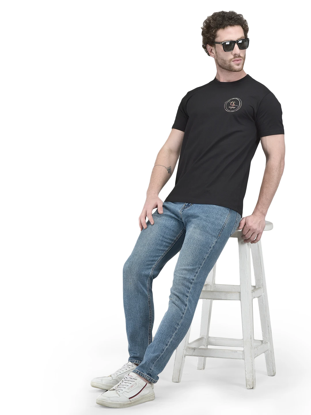 Styled full-length look with the black graphic T-shirt paired with jeans and sunglasses