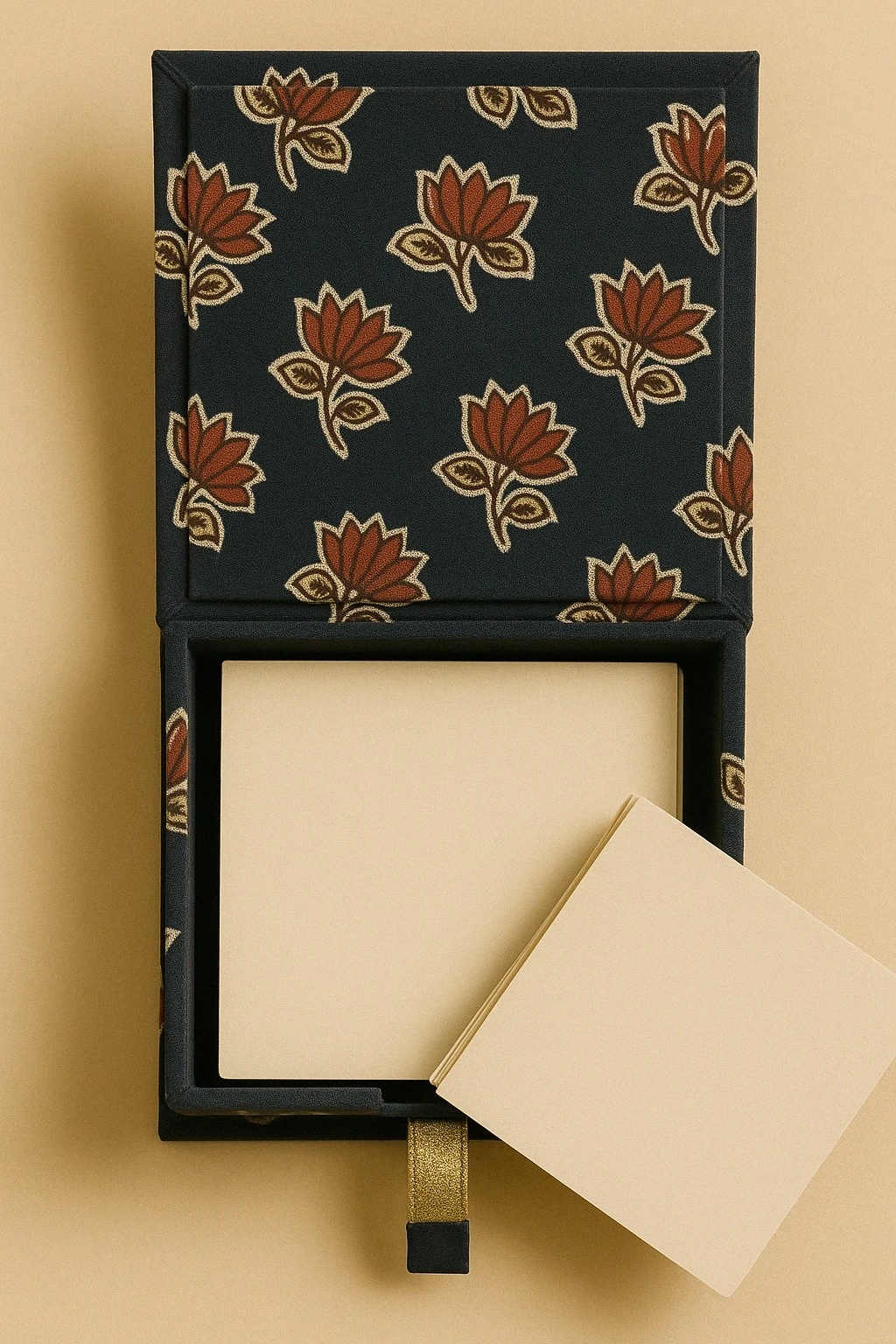 Top view of floral fabric sticky note holder with square paper stack and gold pull tab detail