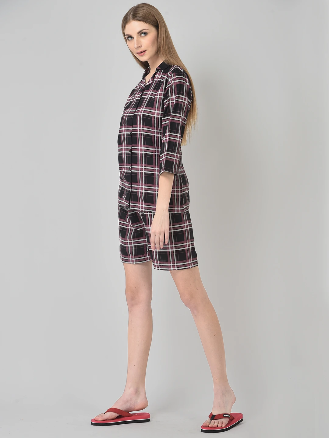 Side-angle view of maroon plaid sleep set with button-front shirt, knee-length shorts, and three-quarter sleeves