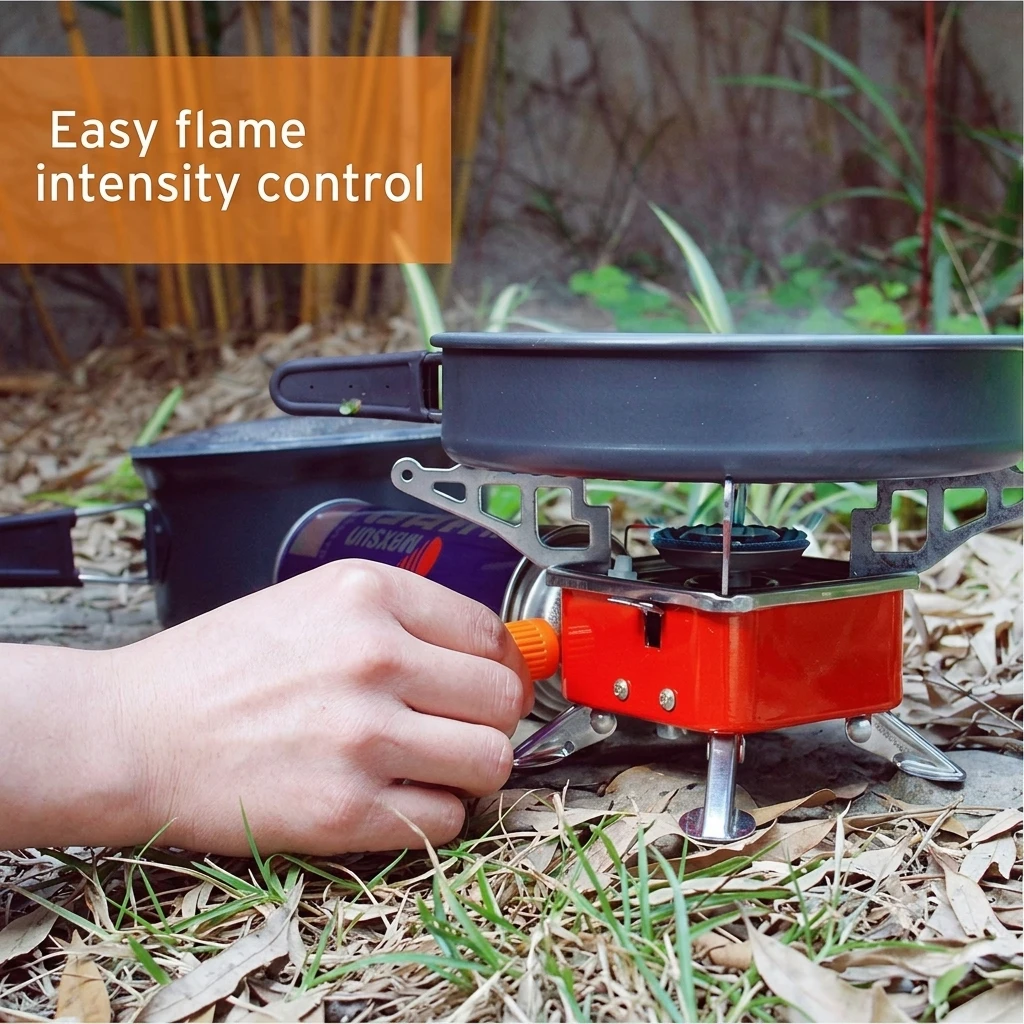 Hand adjusting the orange control knob on a red camping stove with pan on top and text 'Easy flame intensity control'