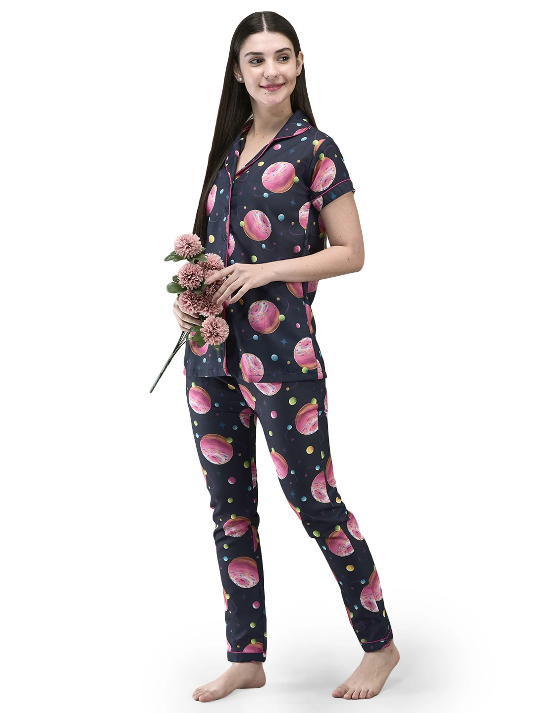 Three-quarter view of the printed night suit styled with pink flowers in hand