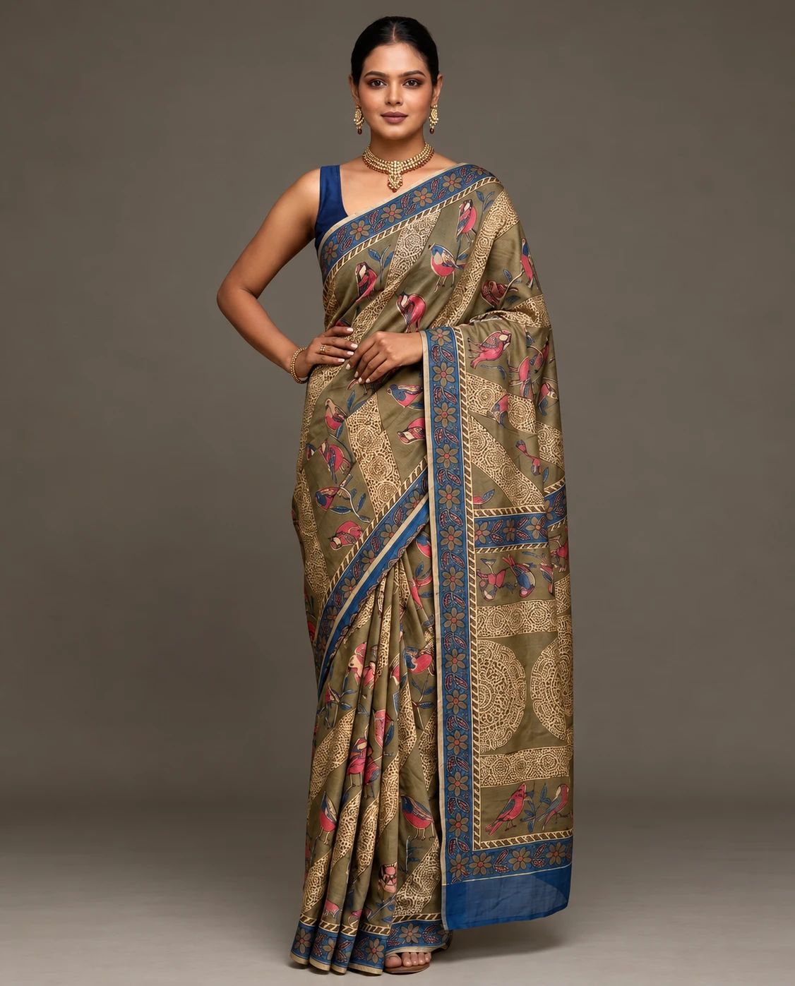 Front full-length view of olive saree with pink bird motifs and wide blue floral border on a model