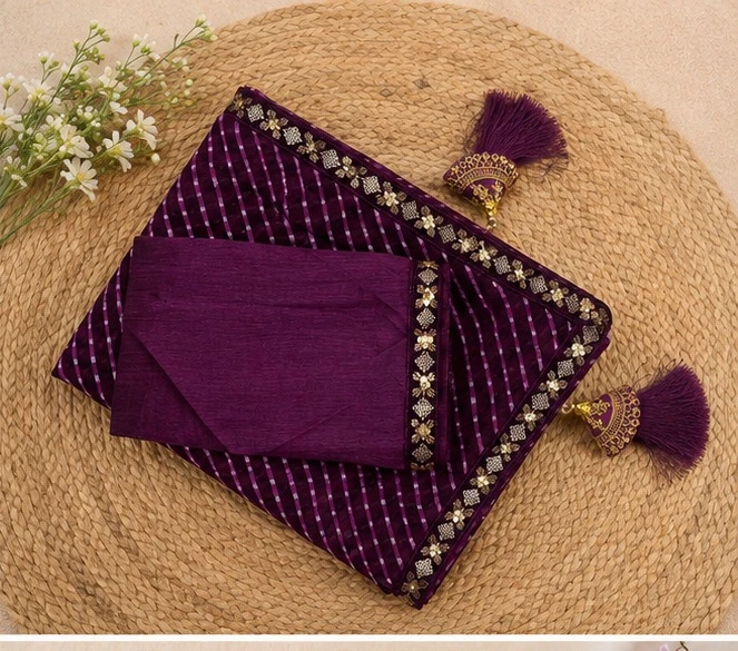 Woman wearing a purple striped saree with gold embroidered border and matching sleeveless blouse