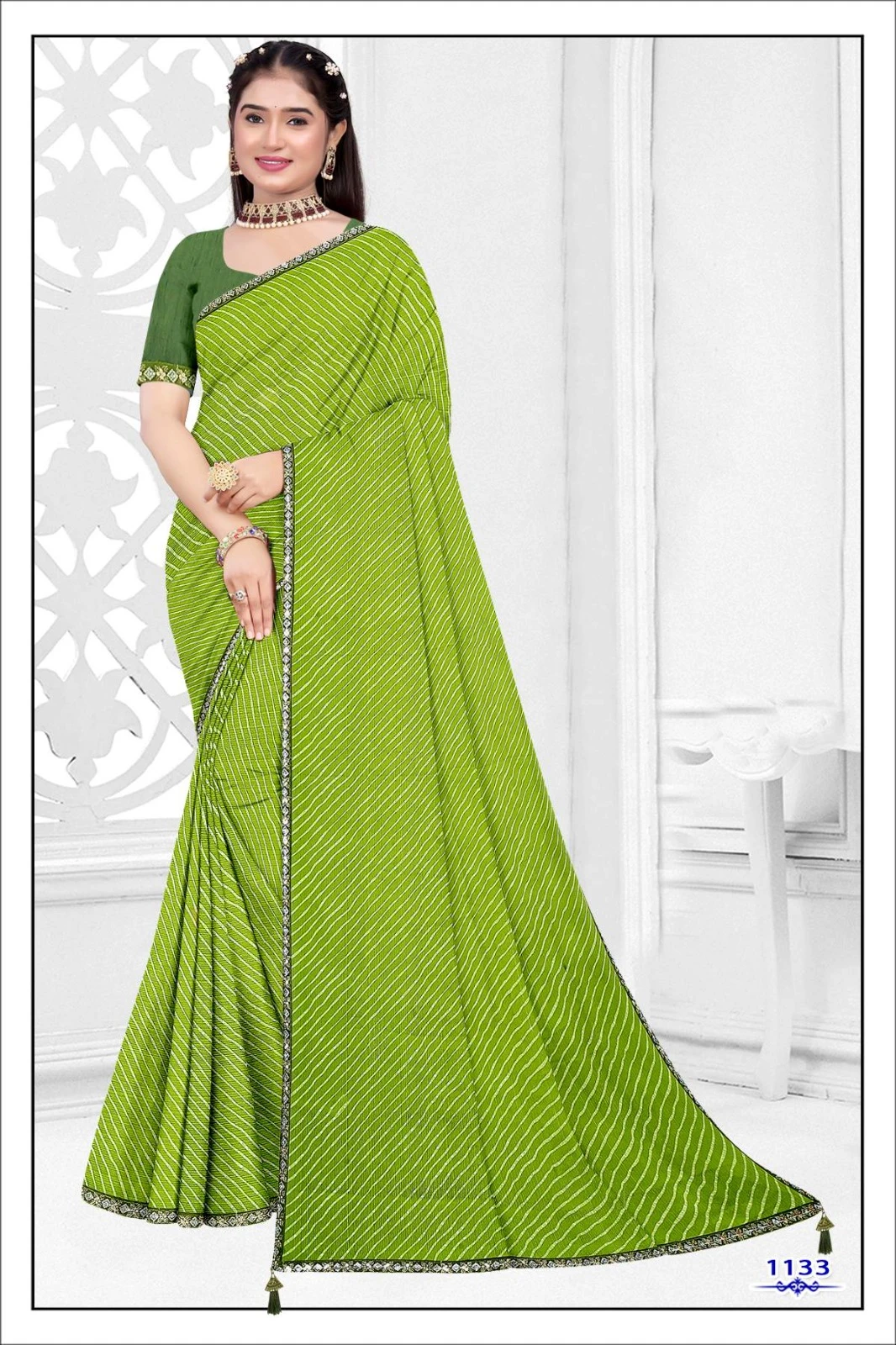 Woman wearing a green leheriya print saree with striped pattern and decorative border