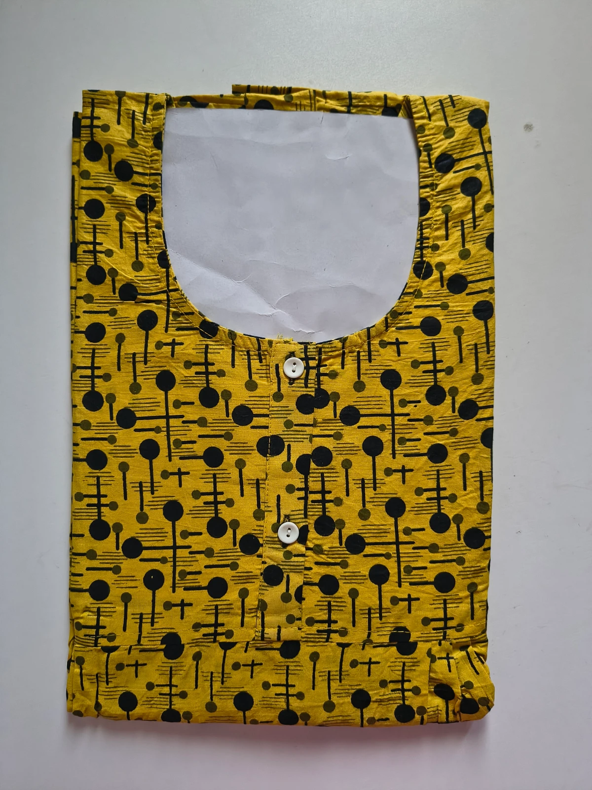 Woman wearing a mustard yellow printed full-length nighty with short sleeves and round neck