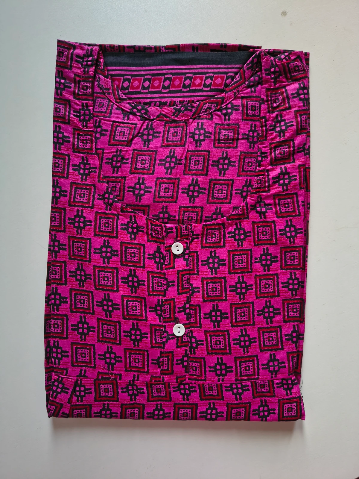 Woman wearing a pink printed full-length nighty with short sleeves and round neck