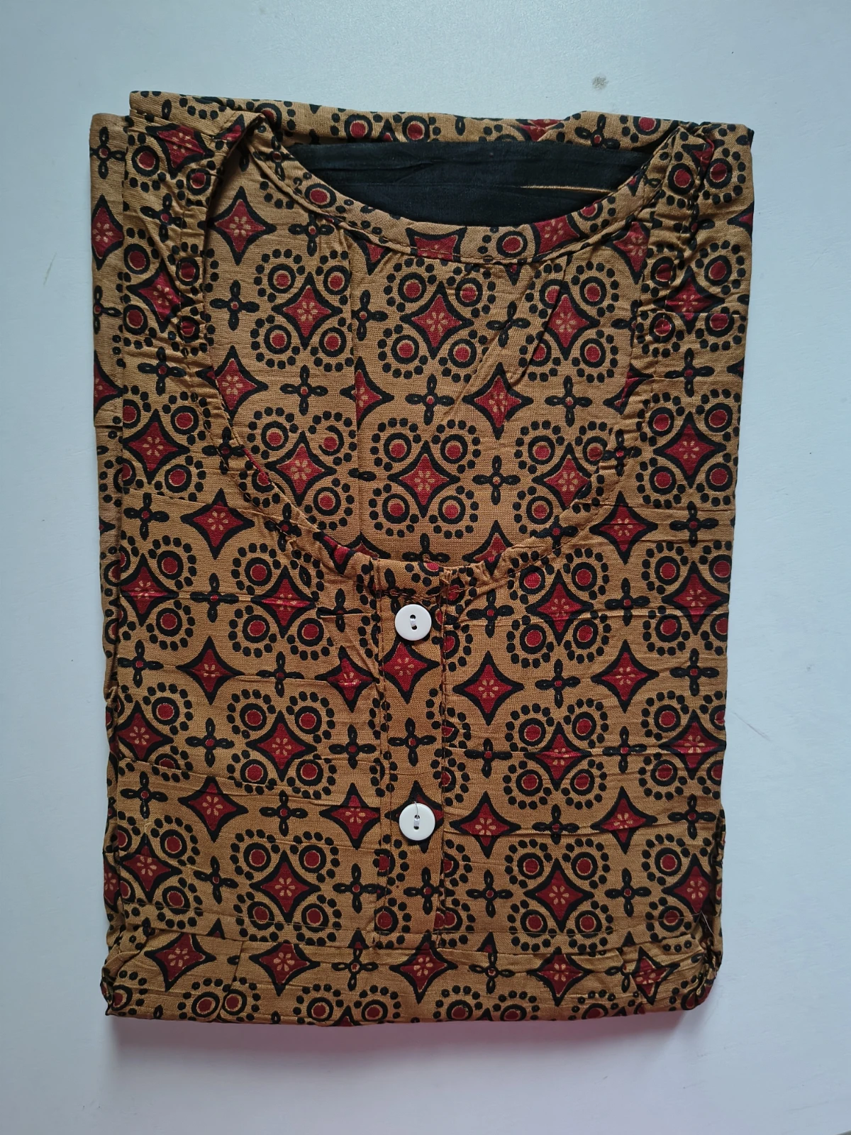 Woman wearing a brown printed full-length nightdress with short sleeves and buttoned round neckline
